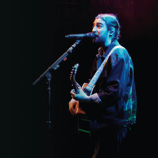 Noah Kahan plays guitar and sings.