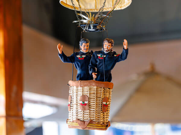 Figurines of Ralph and Joe in a hot air balloon.