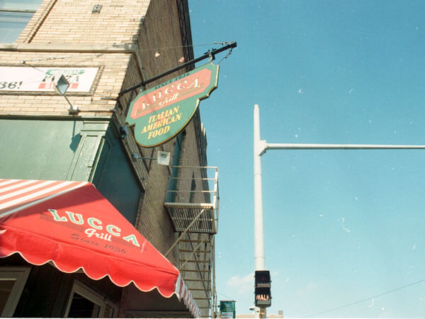 The hanging sign on the Lucca building.