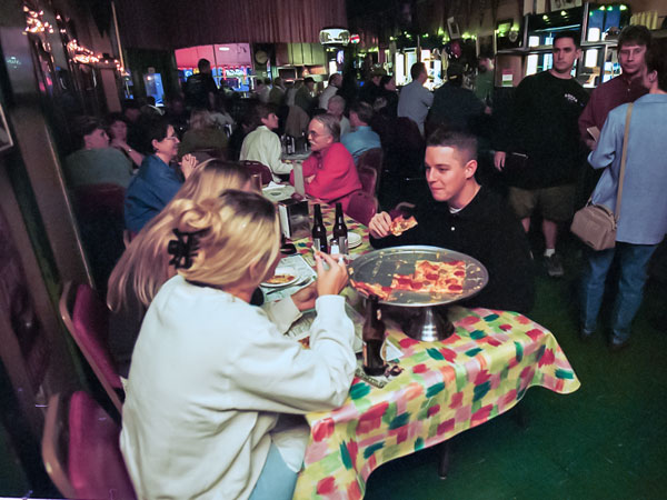 Young people enjoy beer and pizzas inside Lucca Grill.