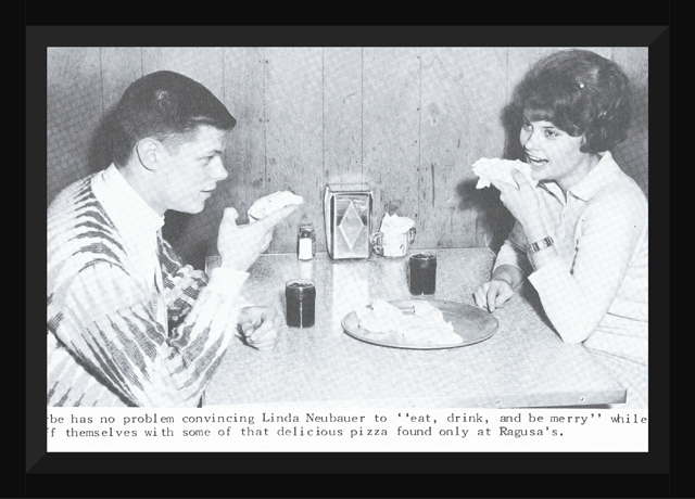 A newspaper photo of a couple eating pizza.