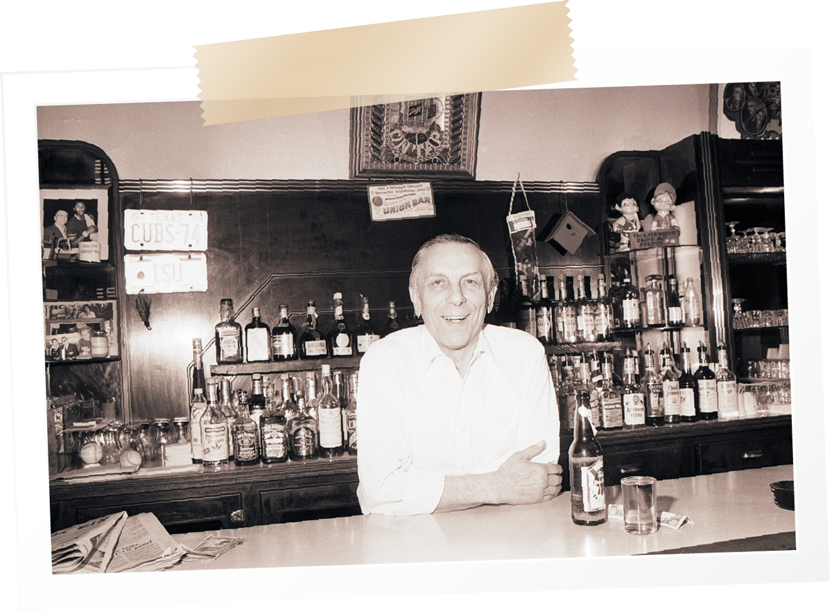 Photo of Tot Baldini leaning on the bar of Lucca's.