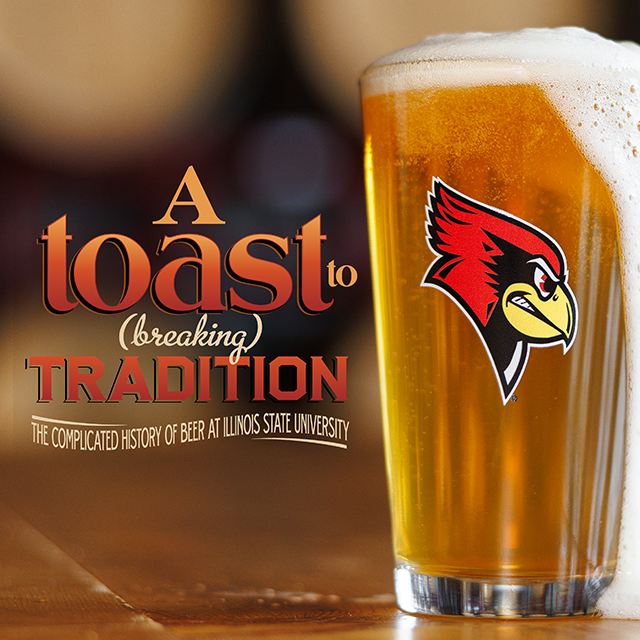 A pint glass of beer with foam overflowing and a Reggie Redbird logo on the glass, against a blurred background of wooden barrels.