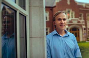 Core director by a campus window