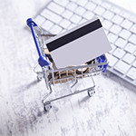 Shopping cart with credit card and keyboard.
