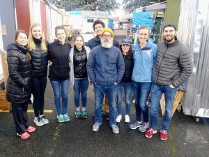 Image of students gathered outdoors, smiling