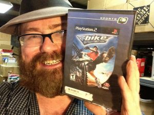 A man smiling with the video game Bike!