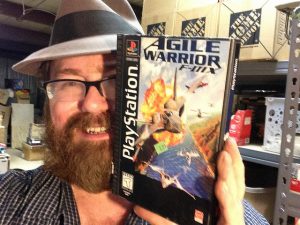 Mike is holding Agile Warrior for Playstation in this picture.