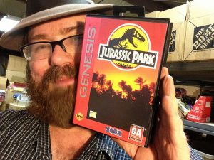 This time he is holding Jurrasic Park for the Genesis.