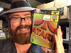 In this photo he is holding a Playstation 2 Atari Anthology.