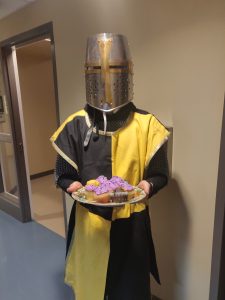 jacob Tashoff in a knight costume holding cupcakes