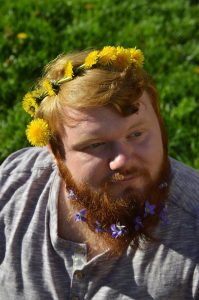 Mitch with flowers in his hair and bows in his beard